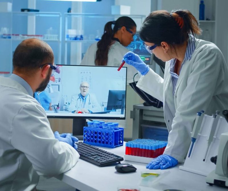 lab-technicians-talking-video-call-with-professional-chemist-doctor-explaning-vaccine-reactions