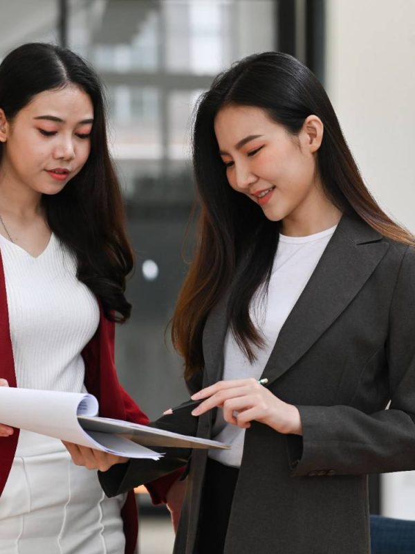 two-confident-businesswomen-sharing-ideas-and-work-2024-11-26-13-54-35-utc