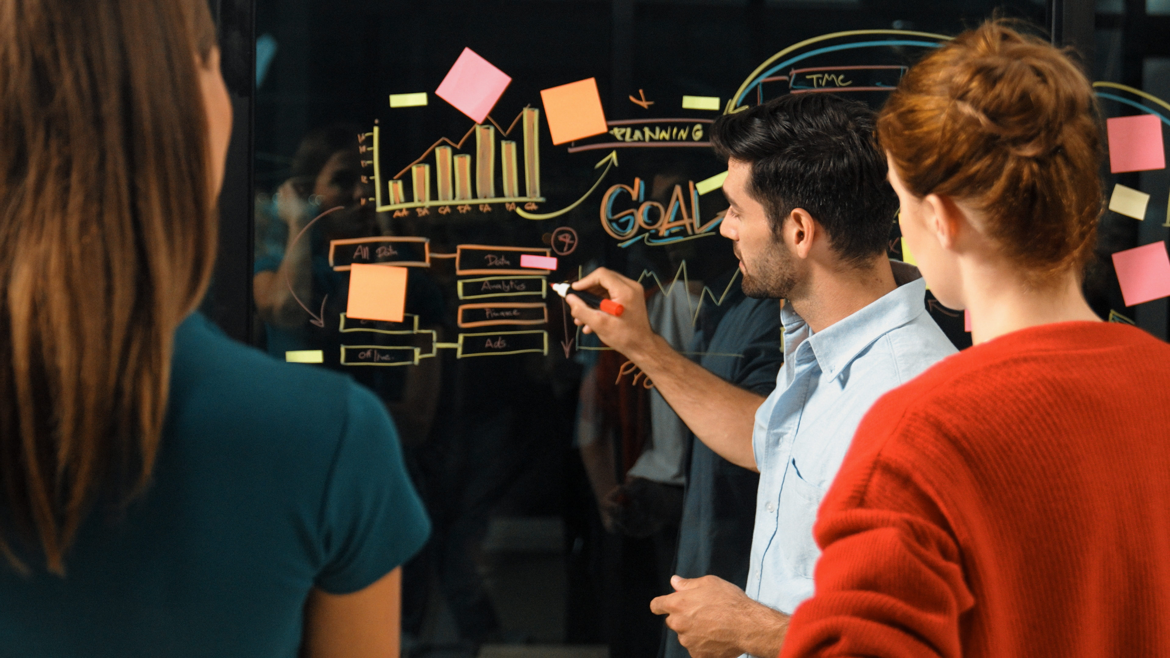 Professional businessman presenting marketing idea or financial plan to smart investor. Executive manager sharing, talking, working together with cooperative colleagues. Business concept. Tracery